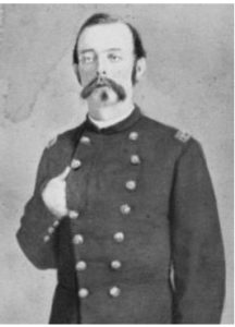 Portrait of William Welsh standing with hand over breast in uniform. 