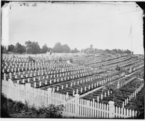 Black and white image of rows of headstones in a cemetery